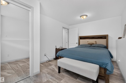 Room featuring wood-finish flooring, a neutral color palette, and a semi-flush mount ceiling light - 5006 53 Avenue, Cold Lake, AB 