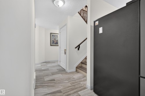 Hallway with light-colored walls and patterned tile flooring - 5006 53 Avenue, Cold Lake, AB 