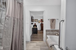 Bathroom featuring a tiled shower surround, built-in bathtub, and chrome fixtures - 