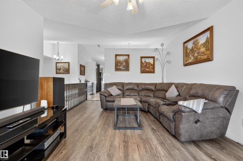 Spacious living area featuring wood-finish flooring, vaulted ceiling, and an open concept layout - 5006 53 Avenue, Cold Lake, AB 