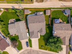 Aerial perspective showcasing a property with extensive landscaping - 