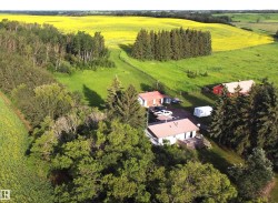 Make this your own country homestead among mature trees and rolling green hills, this acreage includes a comfortable home with upgrades and extra finishing materials already on-site and included to help complete your new space. - 