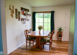 Bright interior space featuring laminate flooring and a large window - 
