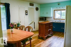 Kitchen and dining area featuring double basin sink, and upper and lower cabinetry - 