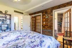 Rustic wood-paneled accent wall featuring two French doors with grid glass panels - 