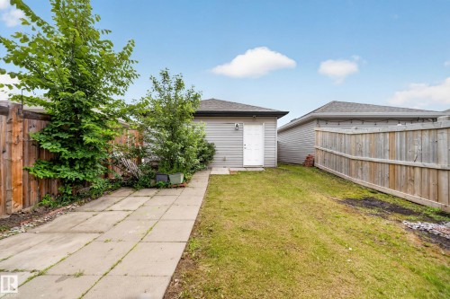 Detached garage with horizontal siding and a side-entry door - 227 Cy Becker Blvd, Edmonton, AB 