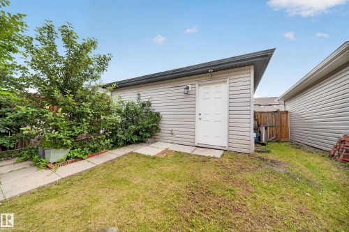 Detached garage with horizontal siding and a single entry door - 227 Cy Becker Blvd, Edmonton, AB 