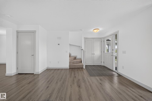 Foyer with wood-finish flooring extending into living areas - 227 Cy Becker Blvd, Edmonton, AB 