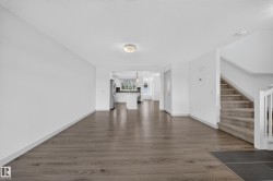 Open concept main level featuring wood-finish flooring - 