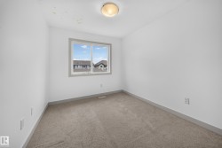 Room featuring neutral carpeting, white walls, and a window with gray trim - 