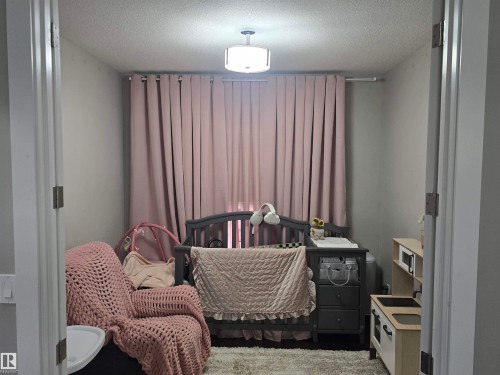Room with light gray walls and a textured ceiling - 1019 175 Street, Edmonton, AB 
