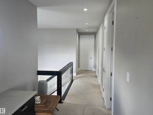 Upper-level hallway with neutral wall tones and recessed ceiling lighting - 1019 175 Street, Edmonton, AB 