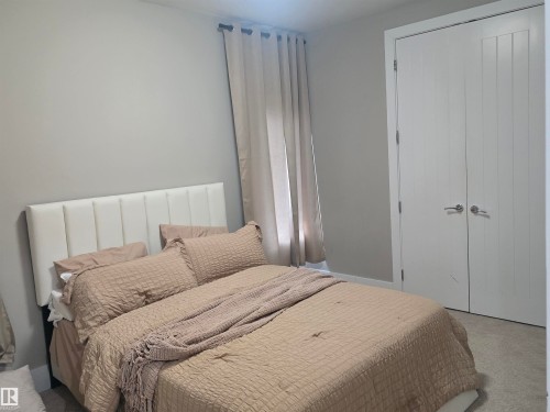 Carpeted room featuring light gray walls and white trim - 1019 175 Street, Edmonton, AB 