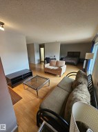 Open concept living area featuring wood-finish flooring throughout - 