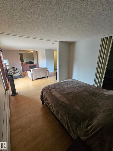 Light wood-finish flooring extends through the space - 10838 108 Street Nw, Edmonton, AB 