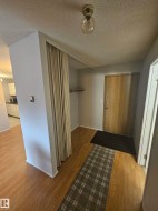 Entryway with wood-finish flooring, a bi-fold closet, and a neutral color palette - 