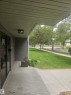 Covered concrete entryway with a flush-mount light fixture - 10838 108 Street Nw, Edmonton, AB 