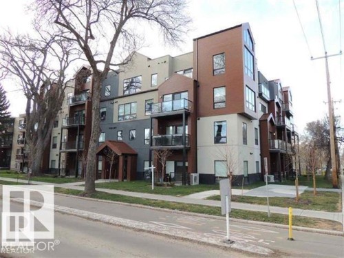 Contemporary multi-story building featuring varied facade materials including wood-look panels and stucco finishes - 103 10006 83 Avenue, Edmonton, AB 