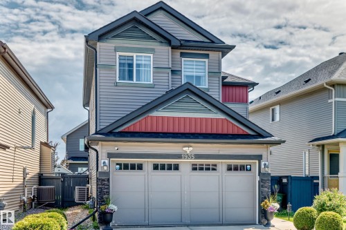 Modern siding exterior featuring a two-car garage with transom windows - 1935 Davidson Wynd Sw, Edmonton, AB 