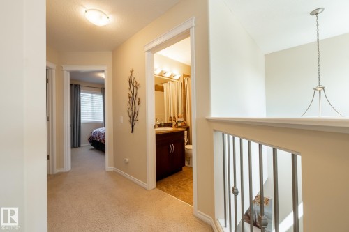 Upper-level hallway with carpet flooring and light beige wall paint - 5820 7 Avenue Sw, Edmonton, AB - Indoor Photo Showing Other Room