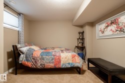 Carpeted interior space featuring a recessed ceiling beam, a rectangular window with horizontal blinds, and neutral wall paint - 