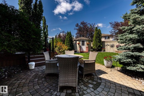 Circular paver patio featuring a stone walkway - 5820 7 Avenue Sw, Edmonton, AB - Outdoor With Deck Patio Veranda