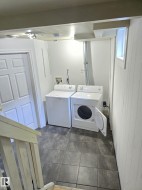 Dedicated laundry area with durable tile flooring - 