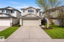 Two-story residential exterior featuring light-toned siding and dark shingle roofing - 3120 25 Avenue, Edmonton, AB 