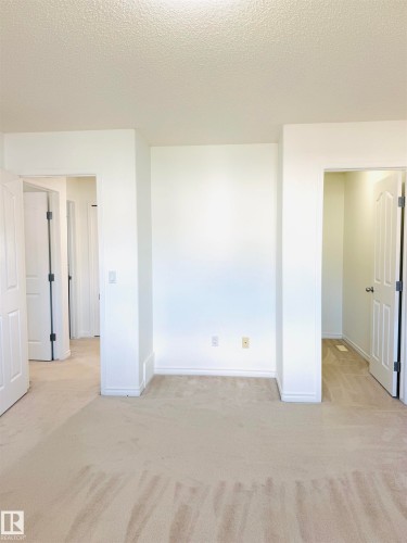 Neutral tone carpeting extending throughout, with white painted walls and trim - 3120 25 Avenue, Edmonton, AB 