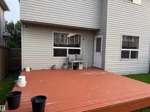 Expansive wood-finish deck with direct access to the interior via a white paneled door - 3120 25 Avenue Nw, Edmonton, AB - Outdoor With Exterior