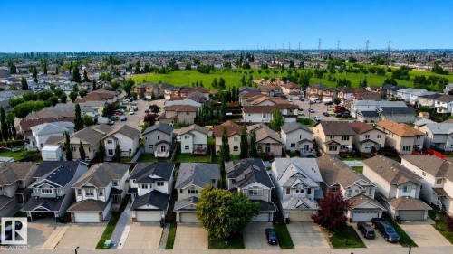 Aerial perspective showcasing a residential area with varied home styles - 3120 25 Avenue Nw, Edmonton, AB - Outdoor With Facade With View