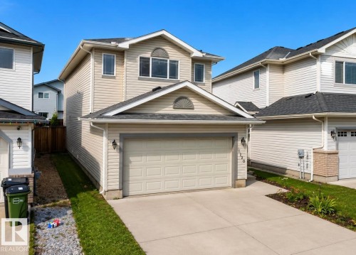 Two-story home featuring light-toned horizontal siding and dark shingle roofing - 3120 25 Avenue Nw, Edmonton, AB - Outdoor
