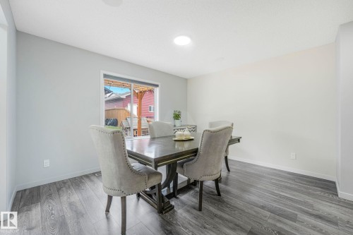 Dining area featuring wood-finish flooring and light-toned walls - 17724 58 Street Nw, Edmonton, AB 
