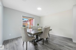 Dining area featuring wood-finish flooring and light-toned walls - 