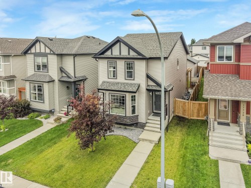 Contemporary two-story residence featuring a light gray facade with dark trim accents - 17724 58 Street Nw, Edmonton, AB 
