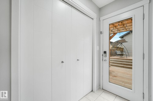 Glass panel door opens to a multi-level wood deck - 17724 58 Street Nw, Edmonton, AB 