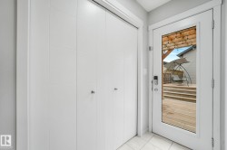 Glass panel door opens to a multi-level wood deck - 