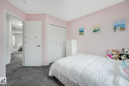Bedroom featuring light pink walls, gray carpet, and white trim - 17724 58 Street Nw, Edmonton, AB 