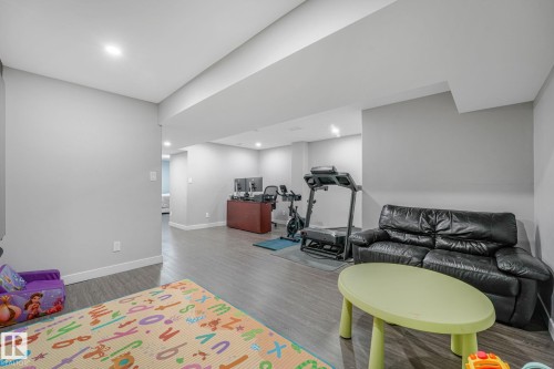 Spacious lower level featuring wood-finish flooring and recessed lighting - 17724 58 Street Nw, Edmonton, AB 