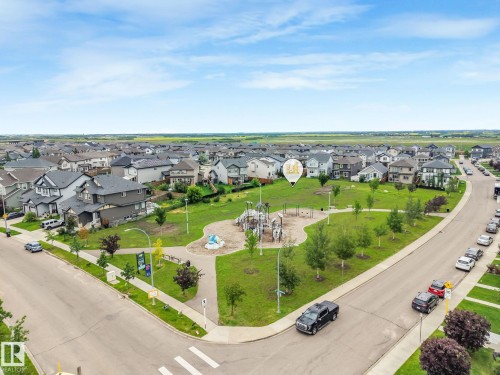 Community park featuring a playground, open green space, and mature trees - 17724 58 Street Nw, Edmonton, AB 