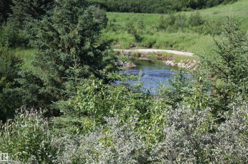 Natural water feature with surrounding lush foliage and mature trees - Rr202 Twp583, Rural Thorhild County, AB 