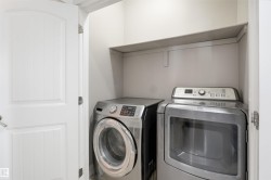 Dedicated laundry area featuring a built-in shelf for storage and a paneled interior door - 