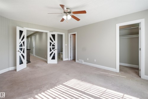 Spacious room featuring neutral carpeting and light gray wall paint - 16807 54 Street, Edmonton, AB - Indoor