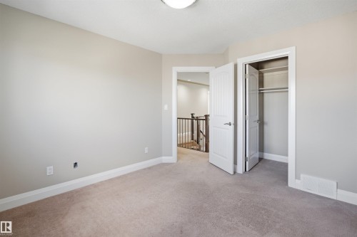 Neutral-toned carpeting paired with light wall paint - 16807 54 Street, Edmonton, AB - Indoor Photo Showing Other Room