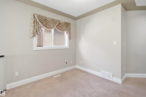 Neutral-toned wall paint and carpeted flooring - 16807 54 Street, Edmonton, AB - Indoor Photo Showing Other Room