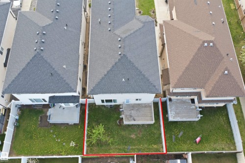 Property featuring a spacious grassy backyard with a mature tree - 16807 54 Street, Edmonton, AB - 