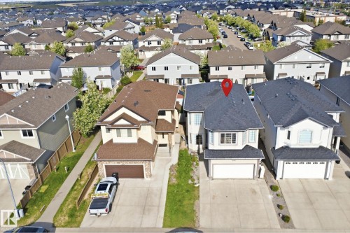 Contemporary two-story residence with attached garage, bay window, and dark shingle roofing - 16807 54 Street, Edmonton, AB - Outdoor With Facade