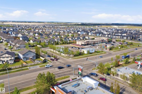 Expansive aerial view showcasing a developed residential neighborhood with numerous detached homes, established street infrastructure, and multiple commercial properties - 16807 54 Street, Edmonton, AB - Outdoor With View