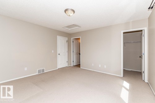 Carpeted interior space featuring light neutral wall paint, white trim, and a semi-flush mount ceiling light - 39 Vega Avenue, Spruce Grove, AB - Indoor Photo Showing Other Room