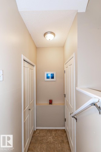 Hallway with neutral tone walls and a textured ceiling - 39 Vega Avenue, Spruce Grove, AB - Indoor Photo Showing Other Room